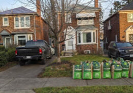 Gardenzilla bags out front of a fall leaf cleanup